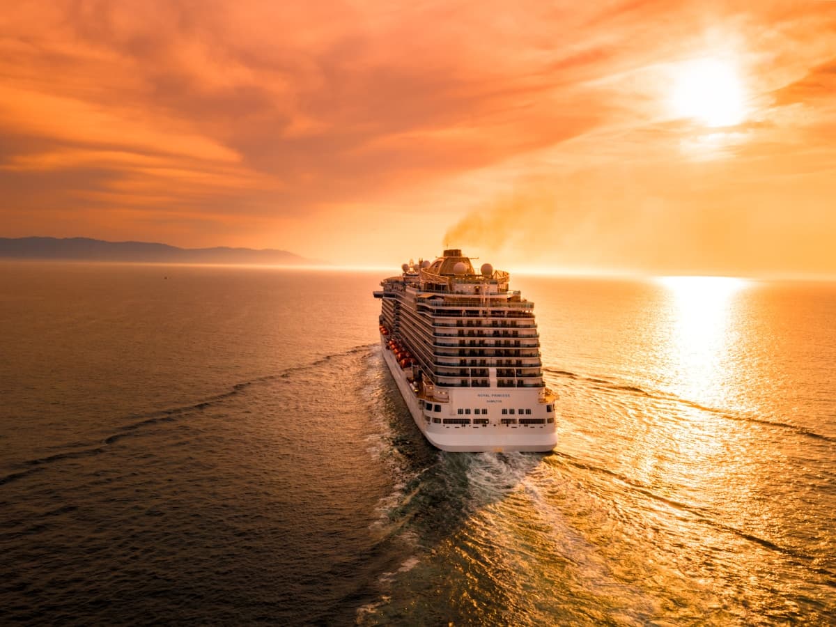 Cruise ship sailing at sunset
